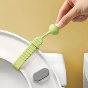 Silicone toilet seat lifter band handle attached to a toilet lid